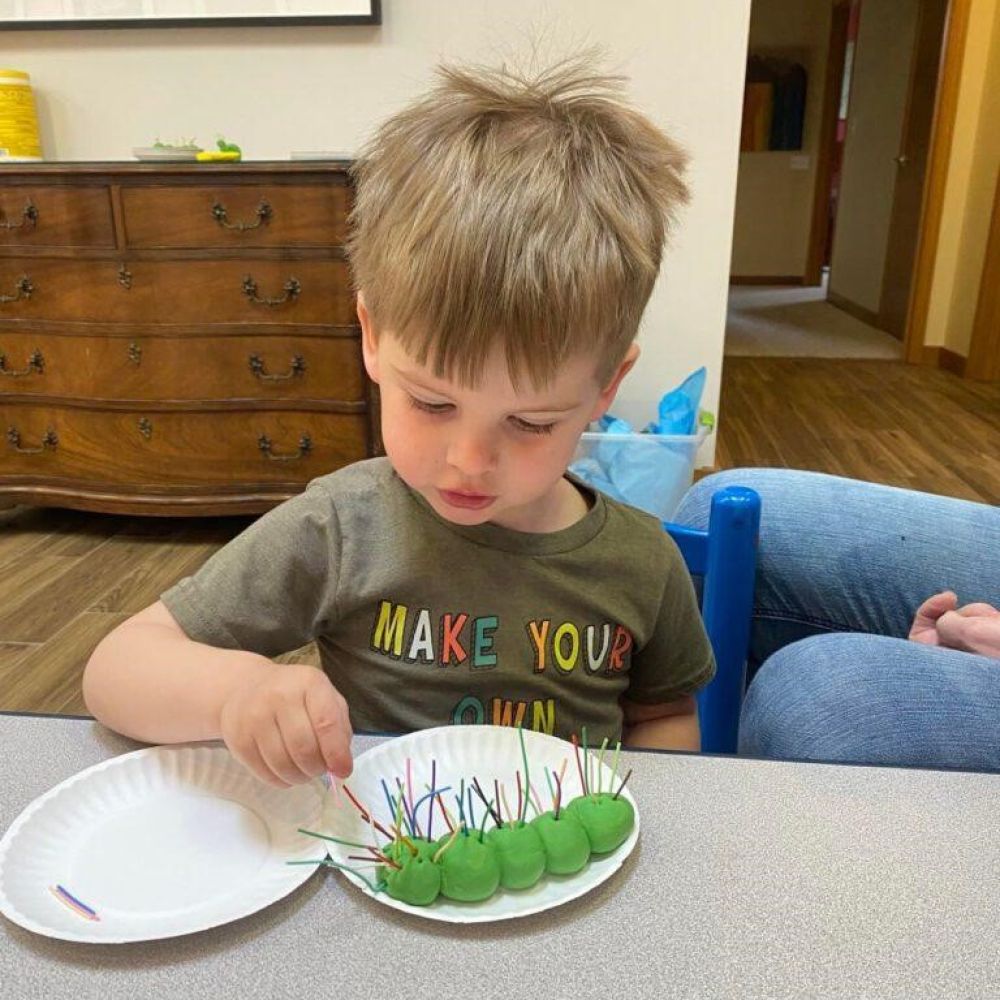 Child creates caterpillar